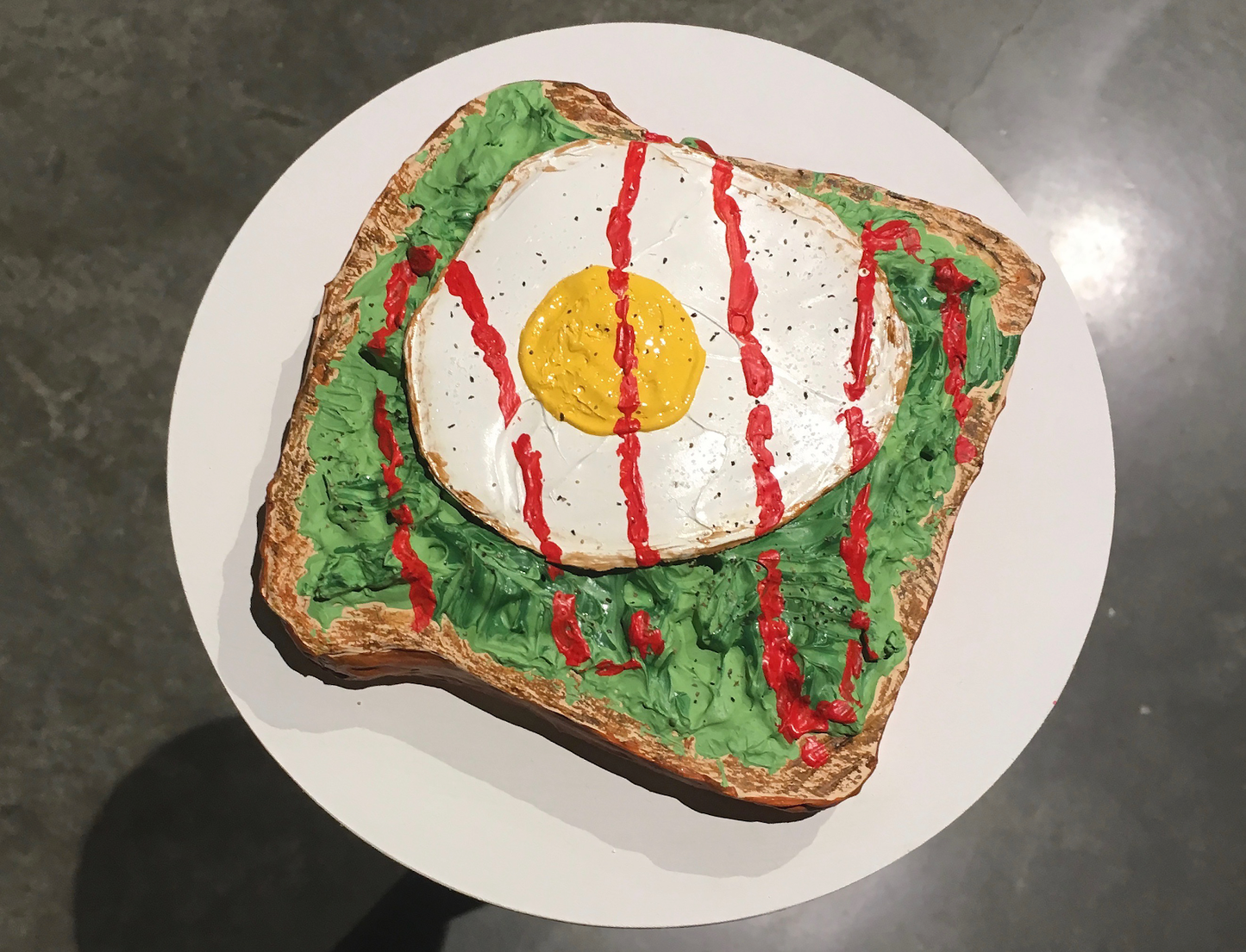 Avo toast with a sunny side up and hot sauce